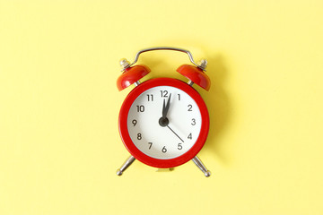 mechanical alarm clock on a colored background