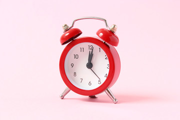 mechanical alarm clock on a colored background