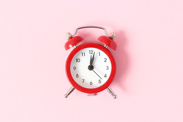 mechanical alarm clock on a colored background