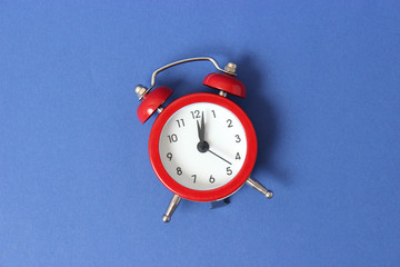 mechanical alarm clock on a colored background
