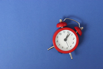 mechanical alarm clock on a colored background