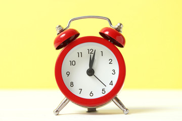 mechanical alarm clock on a colored background
