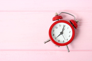 mechanical alarm clock on a colored background