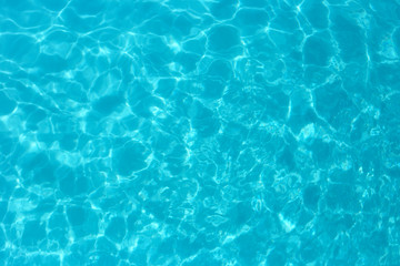 Fototapeta na wymiar Blue color water in swimming pool rippled water detail background.