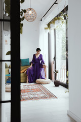 female with short haircut poses in Tbilisi loft