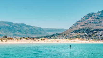 Fototapeten Paddleboarding off the coast of Hout Bay Beach in Cape Town. © SR Productions