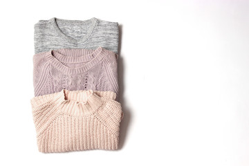 sweaters on a white background top view