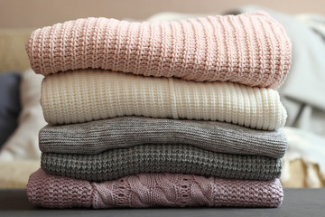 A stack of warm sweaters in the interior of the room.