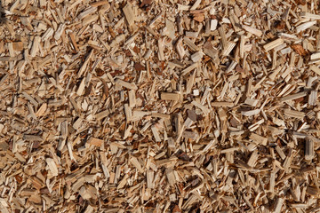 A pile of small sawdust and wood shavings. Abstract textured background for wallpaper in the form of a pattern.
