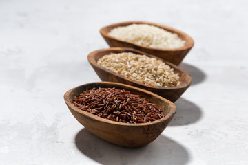 three kinds of dry rice in wooden bowls, top view