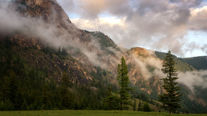sunset landscape in the Altai mountains with fog, Russia, Altai, June
