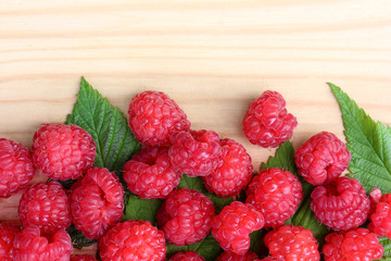 Red raspberry on wooden surface, top view.