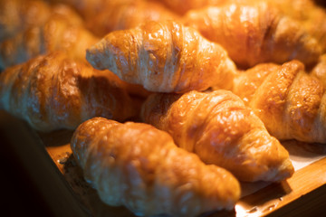 several freshly baked golden croissants Breakfast close up