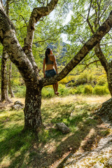 Young woman tourist looking to the top of mountain