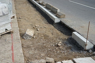 Reconstruction of the sidewalk and replacement of old curbs. Construction zone