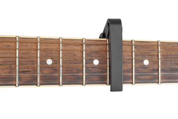 Acoustic guitar neck and capo isolated on white.