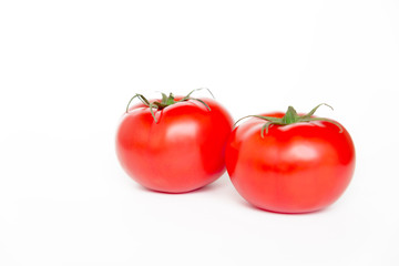Two ripe fresh red tomatoes isolated on white background, side view	