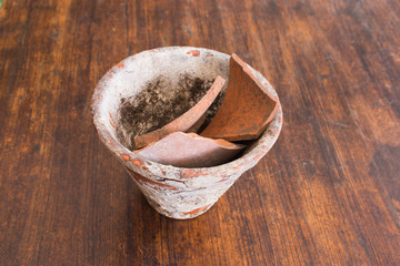Old ceramic flower pot on wooden table