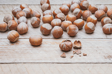 Hazelnut heap on wooden table, selective focus