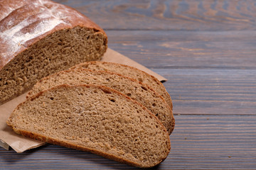 Rustic loaf of artisan bread on dark background.  Dark background.