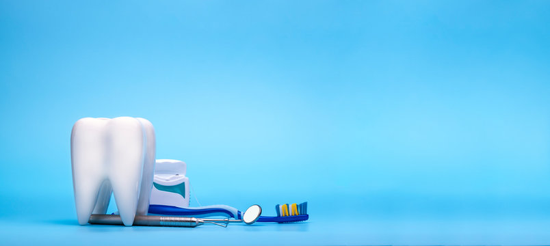 White healthy tooth, different dentist tools for dental care. Dental banner or background.- Image