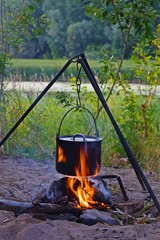 Prepare food and tea in a pot on the fire.Rest on the river Bank.