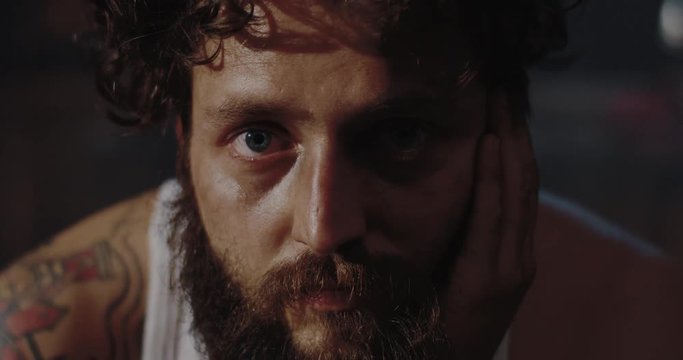 Depressed drug addict looking at camera