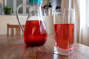 glass and jug of herbal fruit tea