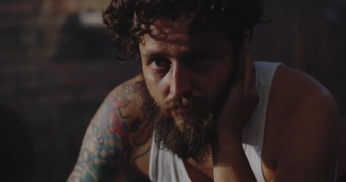 Depressed drug addict looking at camera