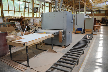 Wood processing machines and pieces of products in a furniture factory