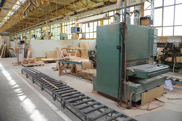 Wood processing machines and pieces of products in a furniture factory