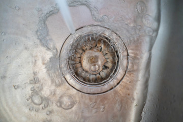 close up water pours throught the wash sink