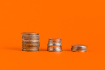 stack of cash coins showing increase graph on color surface