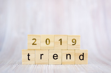 The word trend and 2019 on wooden cube block. 2019 trend concept