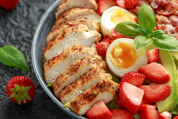 Chicken Cobb salad with strawberries, bacon, avocado and boiled eggs