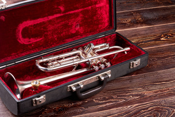 Professional trumpet in velvet case. Brass lacquered trumpet. Classical jazzy instrument. © DenisProduction.com