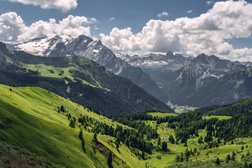 Scenic Alps with green mountain under sky