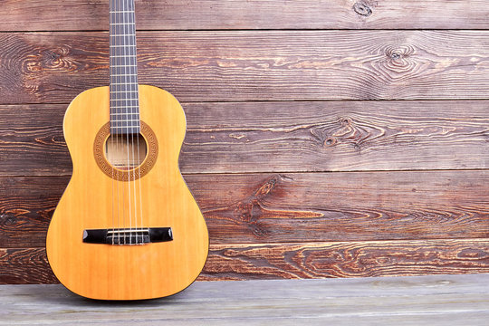 Acoustic guitar and copy space. Classical musical instrument on wooden background.