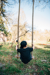 Toddler Swinging on Wooden Swing in Countryside - 280918656