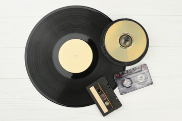 Vinyl plate, DVD discs and audio tapes. Gramophone record, compact disks and audio cassettes on...
