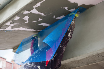 A construction worker installs thermal insulation