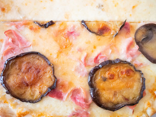 Close up of an Italian pizza with fried eggplant and cheese