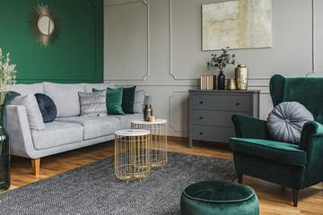 Stylish emerald green and grey living room interior design with abstract painting on the wall © Photographee.eu