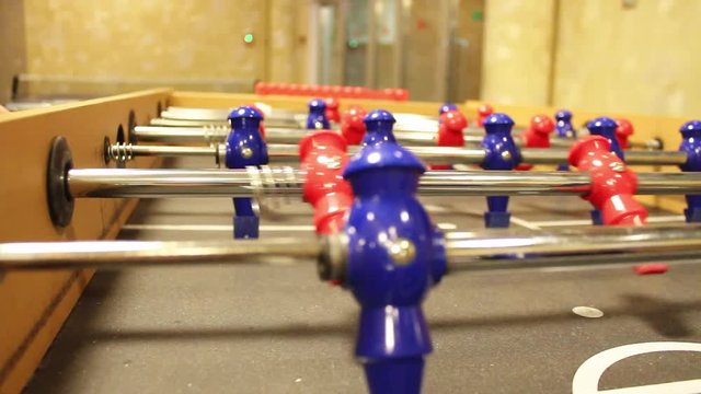 close up of a foosball table in the middle of a game