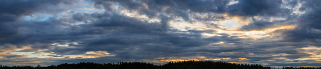Panorama of the sky with beautiful colored whimsical clouds