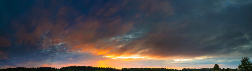 Panorama of the sky with beautiful colored whimsical clouds