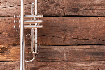 Old trumpet and copy space. Musical instrument trumpet with clipping path on rustic wood...