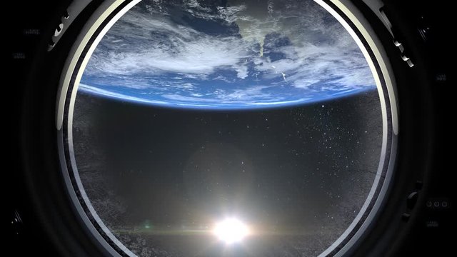 A view of the Earth through the big porthole of a spaceship. International space station is orbiting the Earth. Realistic atmosphere. 3D Volumetric clouds. Space. ISS. 4K. The earth rotates backward.