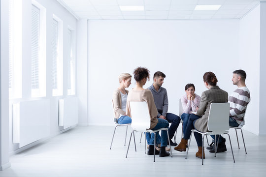 Female psychologist during meeting with a support group for workaholics, photo with copy space