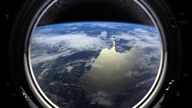 Earth through the porthole window of International space station.